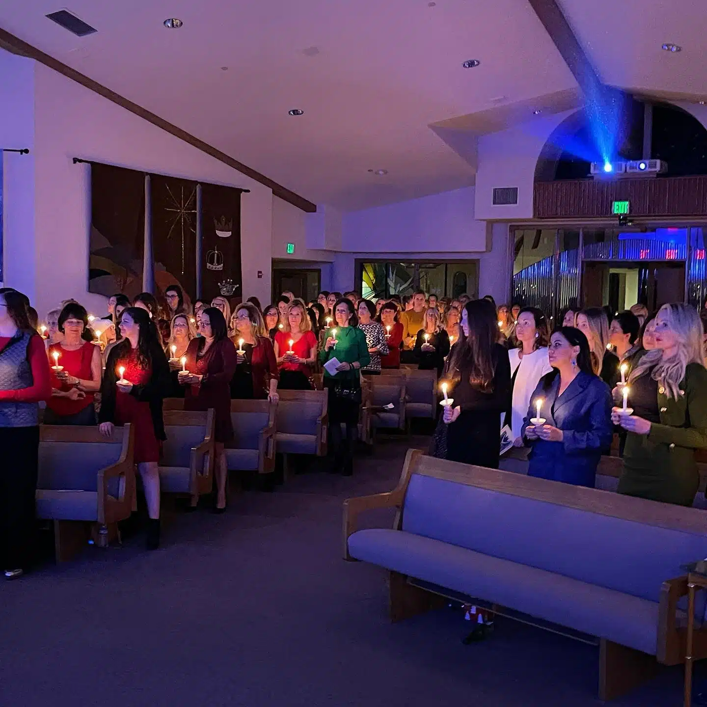 Women holding candles during service